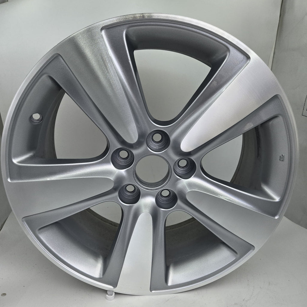 Silver alloy wheel on a light gray background