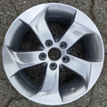 Car wheel rim on a cracked pavement surface
