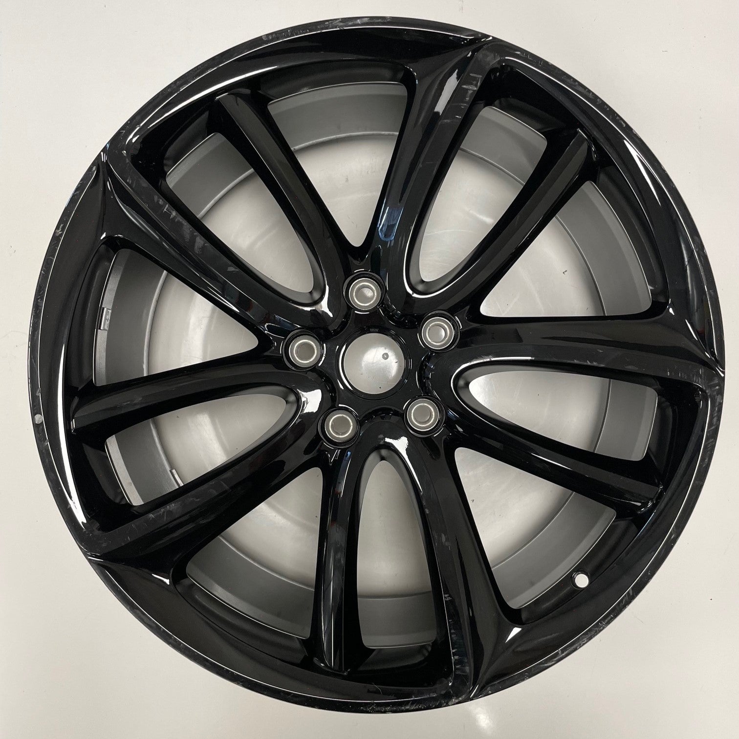 Gloss Black alloy wheel on a white background