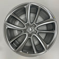 Silver car wheel rim on a gray background