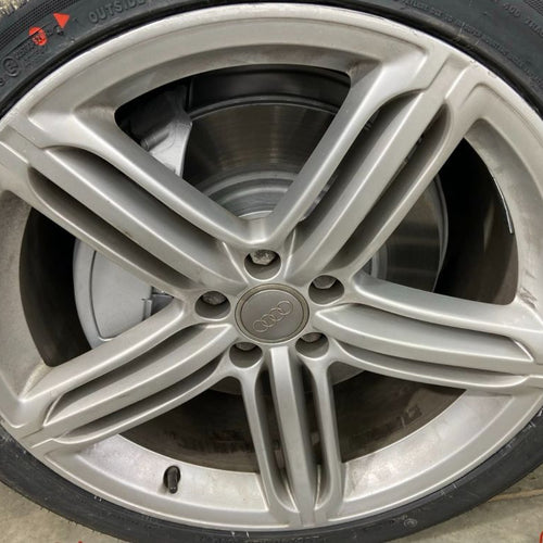 Close-up of a car wheel with a silver alloy rim.