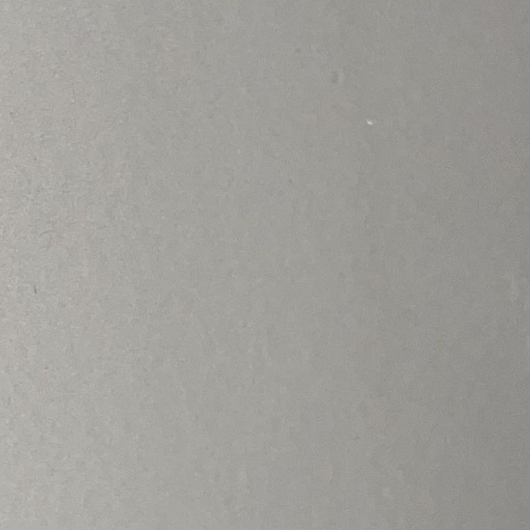 A close-up of a solid gray textured surface, likely a material swatch or solid color sample.