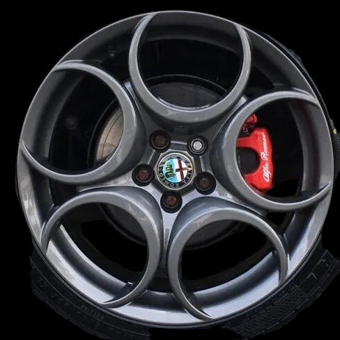 Car wheel with Alfa Romeo logo and red brake caliper