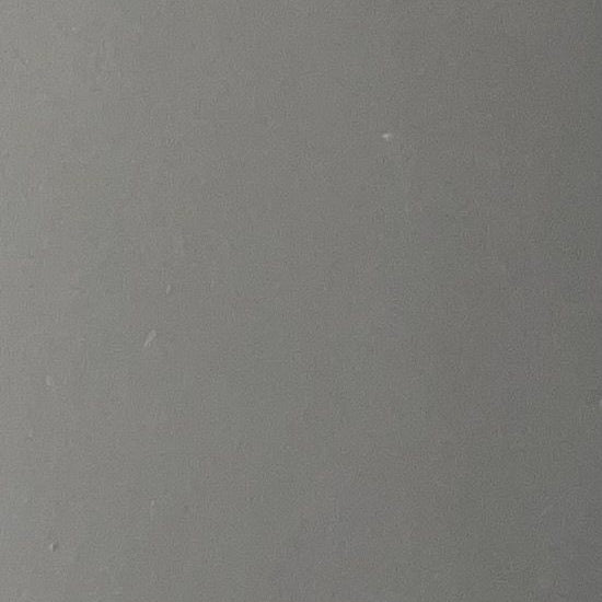 A close-up of a solid gray textured surface, likely a material swatch or solid color sample.