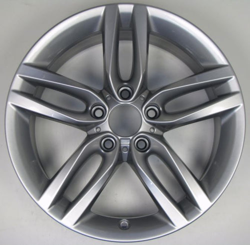 A silver metallic multi-spoke alloy wheel rim photographed from the front against a plain light gray background.