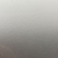 A close-up of a smooth, matte gray surface with a subtle gradient from lighter gray at the top to darker gray at the bottom.