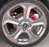 Car wheel with visible brand logo on a clear background