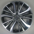 Car wheel rim with a metallic finish on a gray background