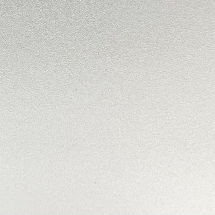 A close-up of a light gray textured surface, likely a fabric or material swatch.