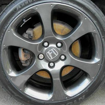 Close-up of a car wheel with a visible Honda logo.