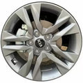 Silver car wheel rim with Kia logo on a white background