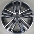 Car wheel rim with metallic finish on a gray background