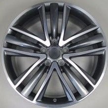 Car wheel rim with metallic finish on a gray background