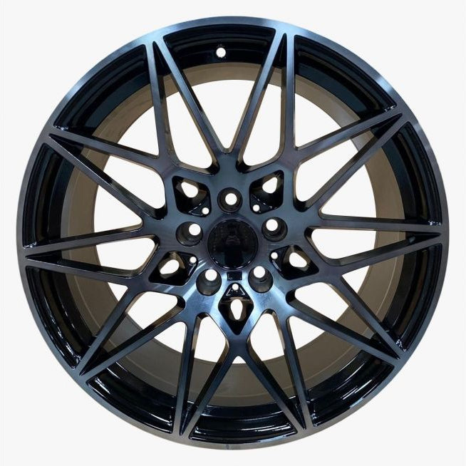 Black alloy wheel on a white background